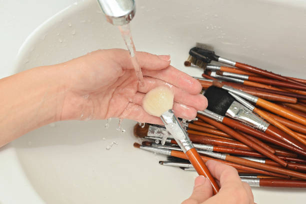 Washing makeup brushes in the sink